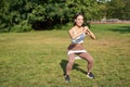 Woman using stretching band, resistance fitness rope for workout in park, doing squats, training on fresh air Royalty Free Stock Photo