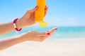 Woman using sunscreen on the beach