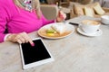 Woman using tablet computer in cafe Royalty Free Stock Photo