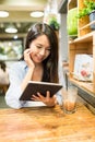 Woman using tablet computer in coffee shop Royalty Free Stock Photo