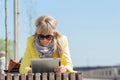Woman using tablet computer outdoors Royalty Free Stock Photo
