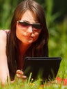 Woman using tablet computer reading outdoors. Royalty Free Stock Photo