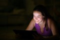 Woman using tablet in the dark Royalty Free Stock Photo