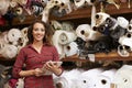 Woman using tablet in fabric storage warehouse, portrait