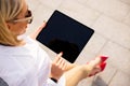 Woman using tablet outdoors, view from above