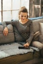 Woman using tablet pc while sitting in apartment Royalty Free Stock Photo