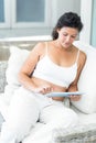Woman using tablet pc on sofa Royalty Free Stock Photo