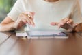 Woman using tablet for sms messages, hand holding pencil typing touchscreen mobile phone in cafe or modern office. lifestyle, Royalty Free Stock Photo