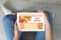 Woman using tablet to order food delivery at home Royalty Free Stock Photo