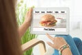 Woman using tablet to order food delivery Royalty Free Stock Photo