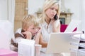 Woman using telephone in office with laptop Royalty Free Stock Photo