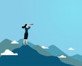 Woman using telescope standing on top mountain