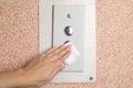 Woman using tissue paper to press elevator call button, closeup