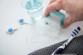 Woman using toothbrush, mouthwash, floss and blue interdental brushes as equipment for daily dental care, prevention and hygiene Royalty Free Stock Photo