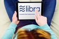 Woman using touch pad with the libra logo, the new crypto currency created by facebook company Royalty Free Stock Photo
