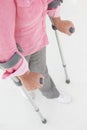 Woman using two crutches
