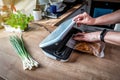 Woman using vacuum seal machine for vacuum packing meat in plastic bags