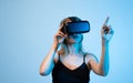 Woman using virtual reality headset and pointing at digital interface, VR design process and interactive user experience Royalty Free Stock Photo