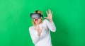 Woman using virtual reality headset. Pretty woman playing game in virtual reality glasses. VR woman. Royalty Free Stock Photo