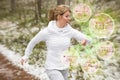 Woman using wearable tech during running workout outdoors