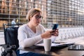 woman using wheelchair using mobile on a terrace Royalty Free Stock Photo