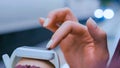 Woman using white smart watch on subway platform Royalty Free Stock Photo