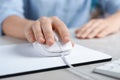 Woman using wired computer mouse on pad at grey marble table, closeup Royalty Free Stock Photo