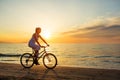 Woman on vacation biking at beach