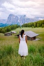 Woman on vacation in the Dolomites Italy,Alpe di Siusi - Seiser Alm with Sassolungo - Langkofel mountain group in