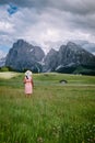 Woman on vacation in the Dolomites Italy,Alpe di Siusi - Seiser Alm with Sassolungo - Langkofel mountain group in