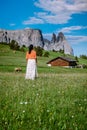 Woman on vacation in the Dolomites Italy,Alpe di Siusi - Seiser Alm with Sassolungo - Langkofel mountain group in