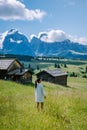 Woman on vacation in the Dolomites Italy,Alpe di Siusi - Seiser Alm with Sassolungo - Langkofel mountain group in