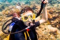 Woman in vacation scuba diving to tropical coral reef Royalty Free Stock Photo