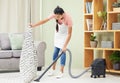Woman, vacuum and carpet in home, living room and spring cleaning service for dust, bacteria or dirt for health. Girl Royalty Free Stock Photo