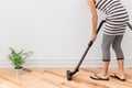 Woman vacuum cleaning the room