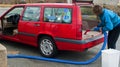 Woman vacuuming car