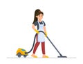 Woman vacuuming house. Young woman in apron holding vacuum cleaner. Royalty Free Stock Photo