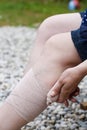 Woman with varicose veins applying compression bandage Royalty Free Stock Photo