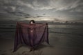 Woman with a veil on the beach Royalty Free Stock Photo