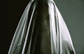 Woman, veil and person as ghost, spirit and surreal for scary, death and horror on dark background. Creepy, dramatic and