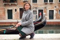 Woman in Venice, Italy. Cute smiling girl on venetian canal with gondolas. Happy young woman in Venice Royalty Free Stock Photo