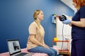 Woman with vertigo symptoms is on appointment of neurologist. Doctor making positional testing of patient with using VNG for