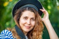 woman in a vest and capless cap