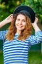 woman in a vest and capless cap