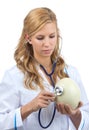 Woman veterinarian auscultating ostrich egg