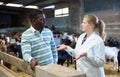 Woman veterinarian talking to goat breeder