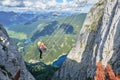 Woman on via ferrata ladder above Gosau lake, on the Intersport Klettersteig Donnerkogel route, in Austria.