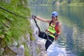 Woman on via ferrata at lake Gosau, Austria, in the Summer. Active people, adventure, tourism.