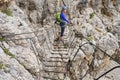 Woman on a via ferrata suspended wire bridge at Cesare Piazzetta klettersteig route, Sella group, Dolomites mountains, Italy Royalty Free Stock Photo
