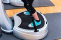 Woman on vibrating plates in gym training Royalty Free Stock Photo